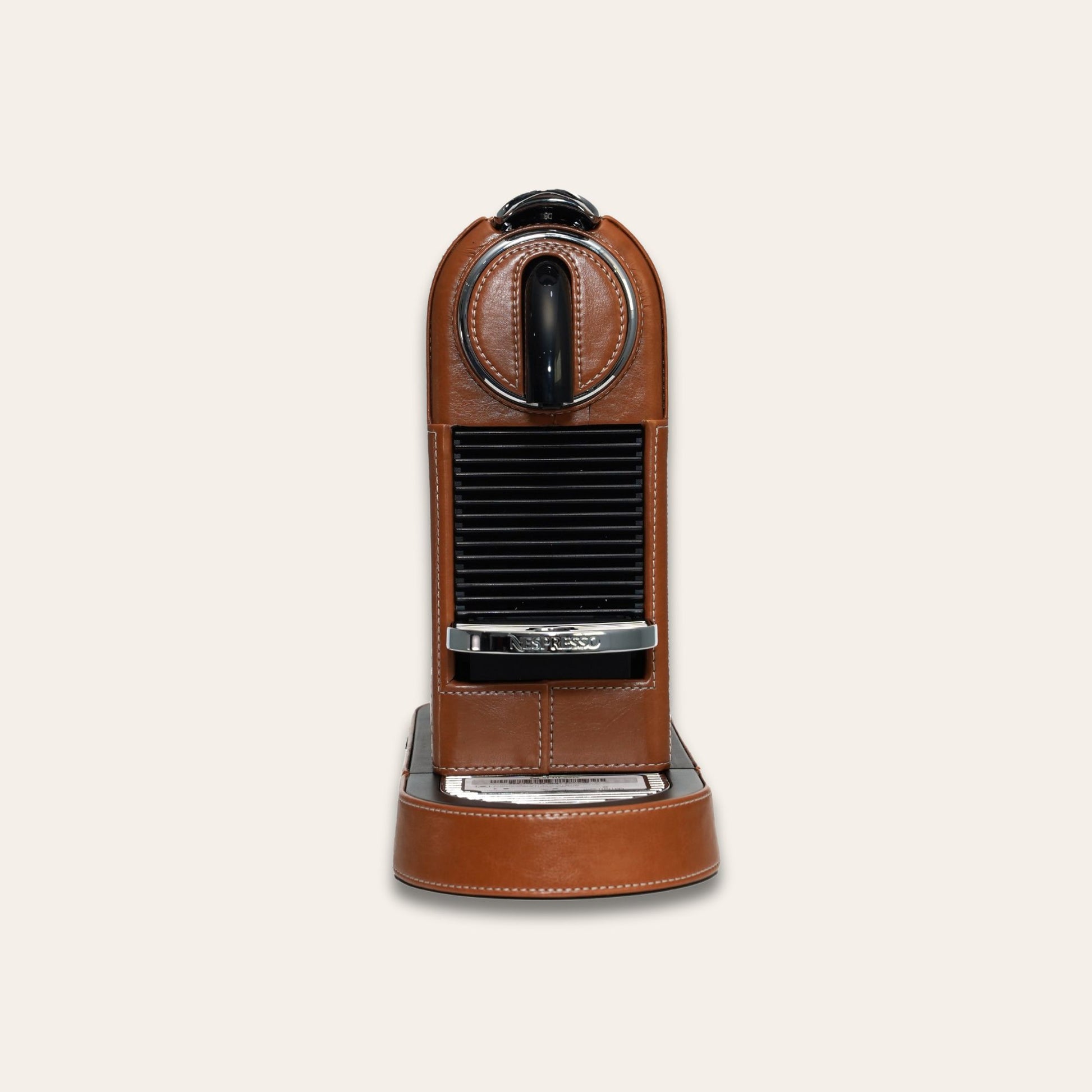 Front view of the stylish Citiz Nespresso coffee machine wrapped in a shiny brown vegan leather with a for an elegant living space
