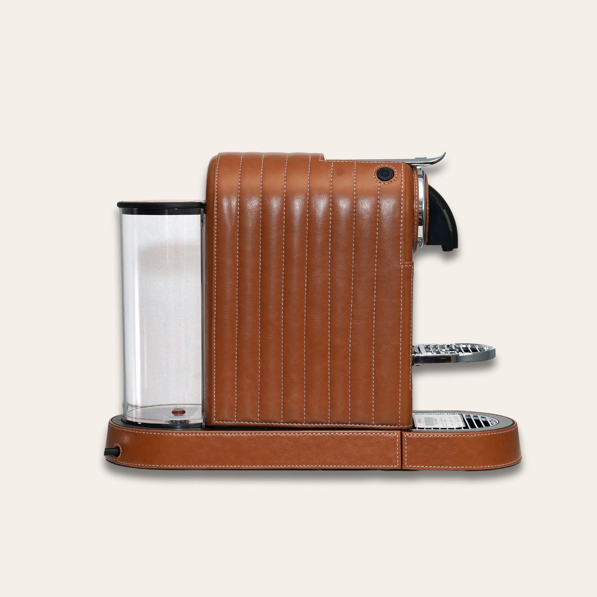 Side view of the stylish Citiz Nespresso coffee machine wrapped in a shiny brown vegan leather with a for an elegant living space