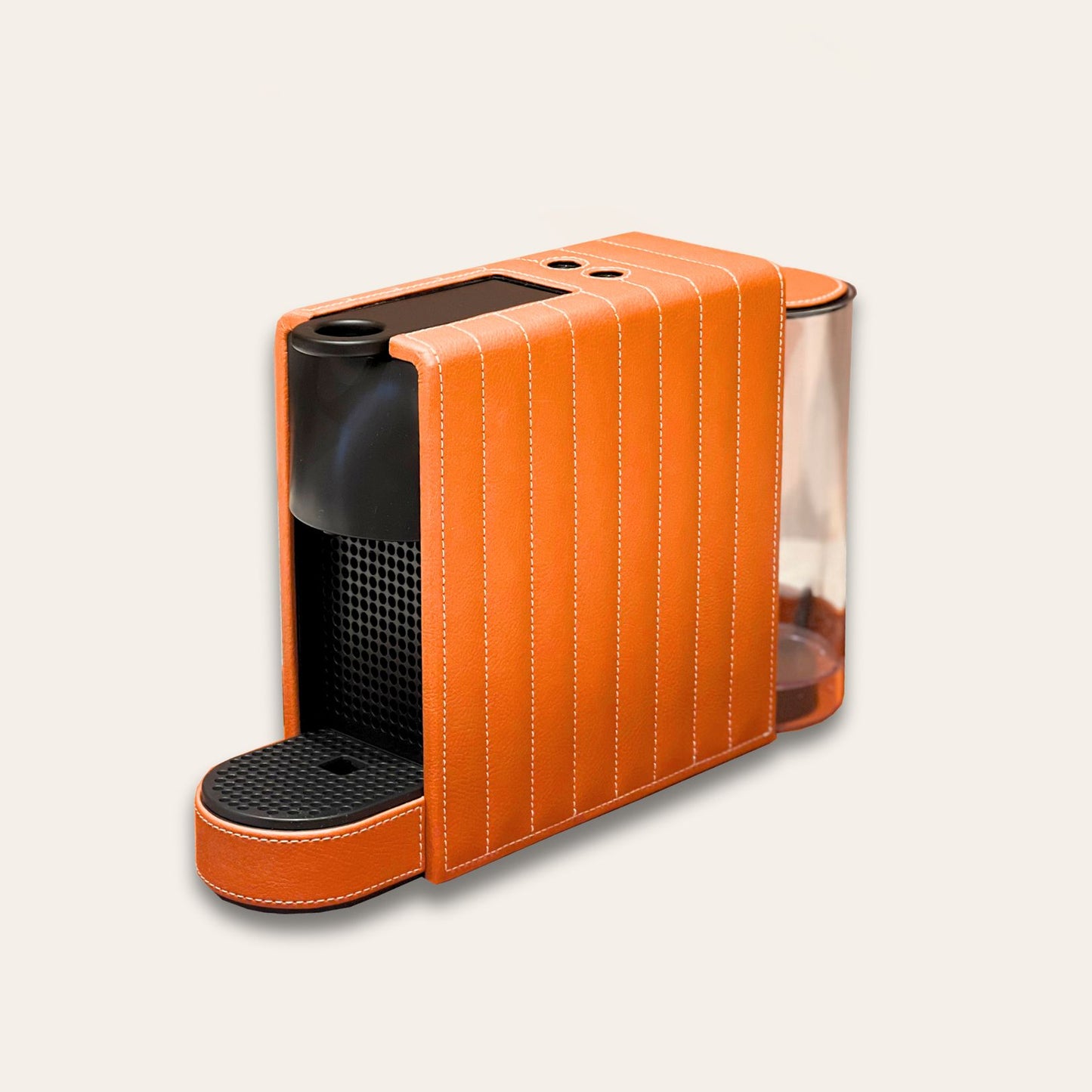 Nespresso Essenza Mini coffee machine featuring a stylish bright orange vegan leather covering, perfect for small spaces.