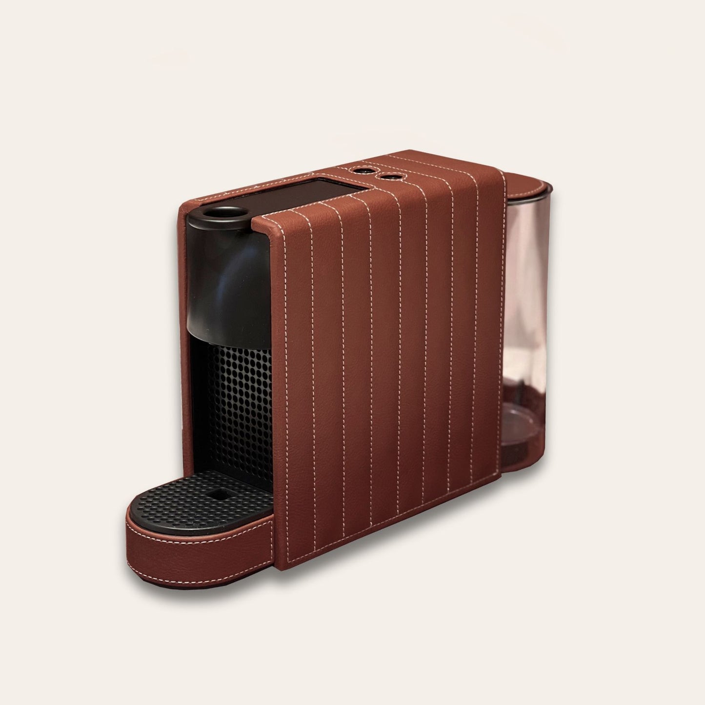 Nespresso Essenza Mini coffee machine featuring a stylish chocolate brown vegan leather covering, perfect for small spaces.