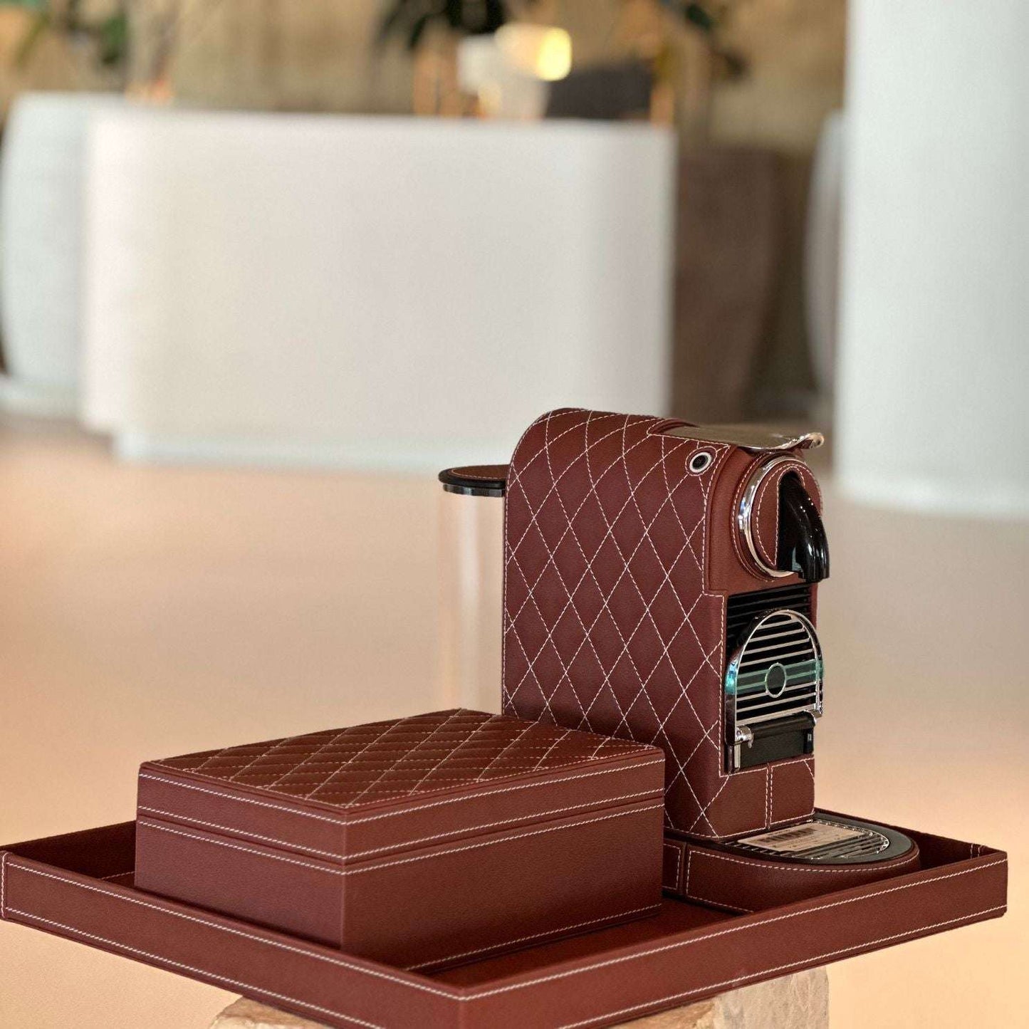 Nespresso Citiz Coffee Machine covered in a chocolate brown colored vegan leather with a storage box for cups, spoons or capsules. Both have a diamond quilting pattern.
