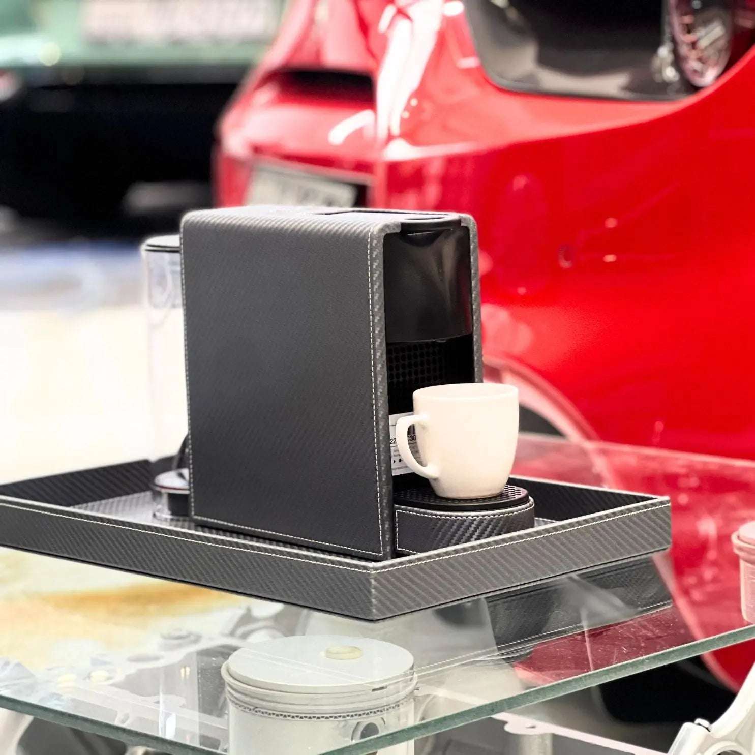 Nespresso Essenza Mini coffee machine featuring a stylish metallic carbon fibre effect vegan leather covering, perfect for small spaces.