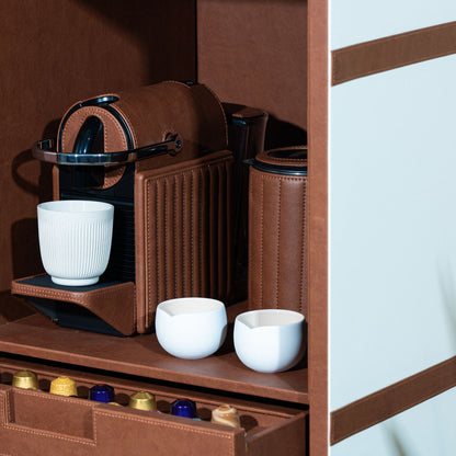 Tan leather cladded nespresso machine inside the luxe cabinet hand-made in dubai. This cabinet has two drawers with space to tstore your coffee capsules