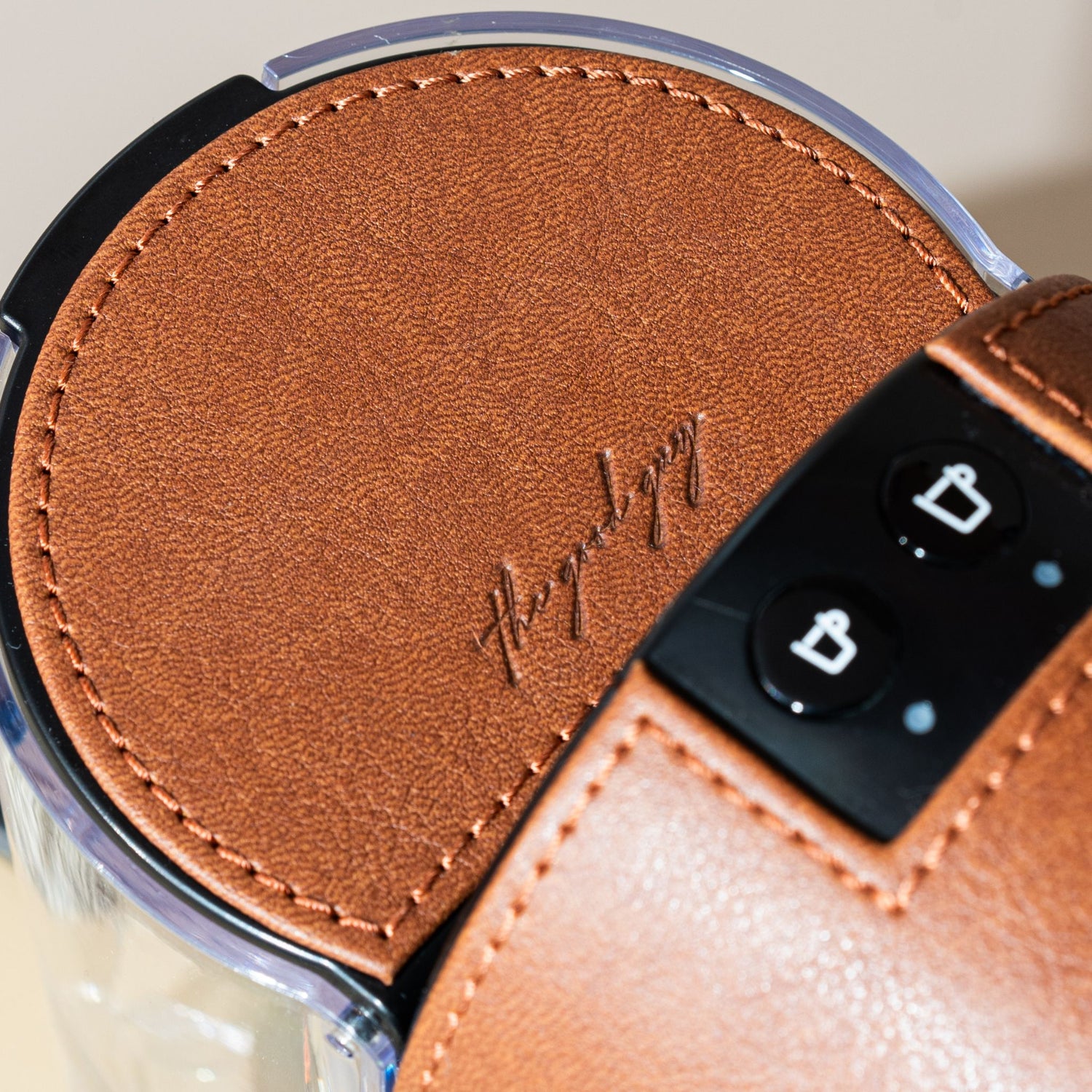 Details of the vegan leather cladded nespresso machine in tan brown
