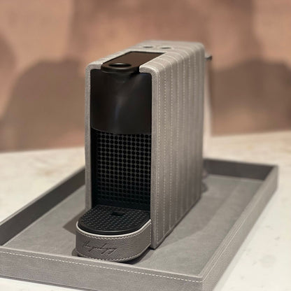 Nespresso Essenza Mini coffee machine featuring a stylish silver grey vegan leather covering, perfect for small spaces.