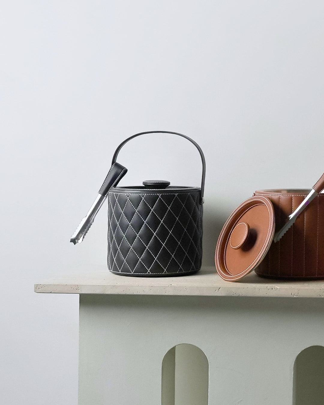 leather wrapped ​Luxe Ice Buckets in black and tan with diamond stitching